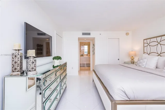 a bathroom with a sink double vanity granite tub shower and a mirror