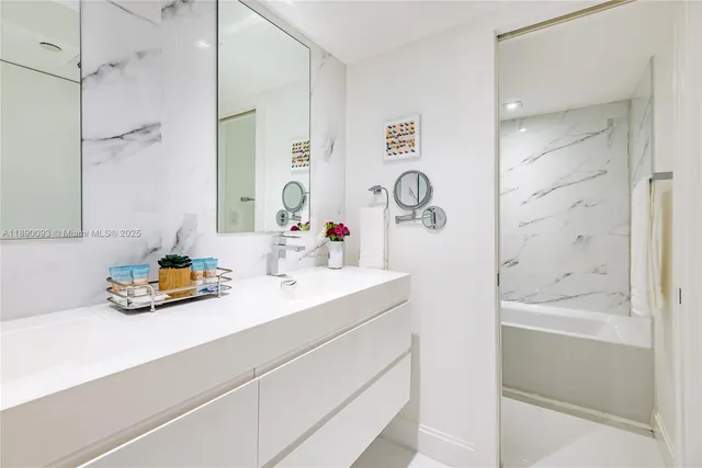 a bathroom with a bathtub and shower