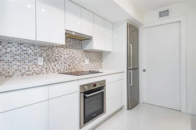 a bathroom with a sink a stove and a mirror