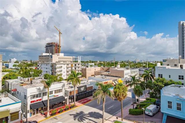 a living room with furniture and chandelier