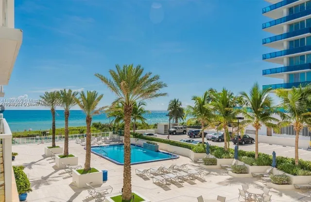 a building with swimming pool in front of it