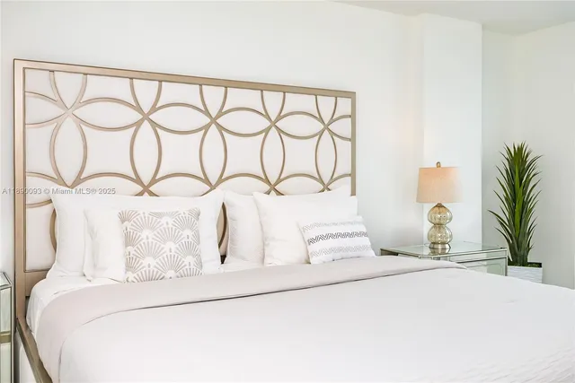 a large bedroom with a large bed and a large window