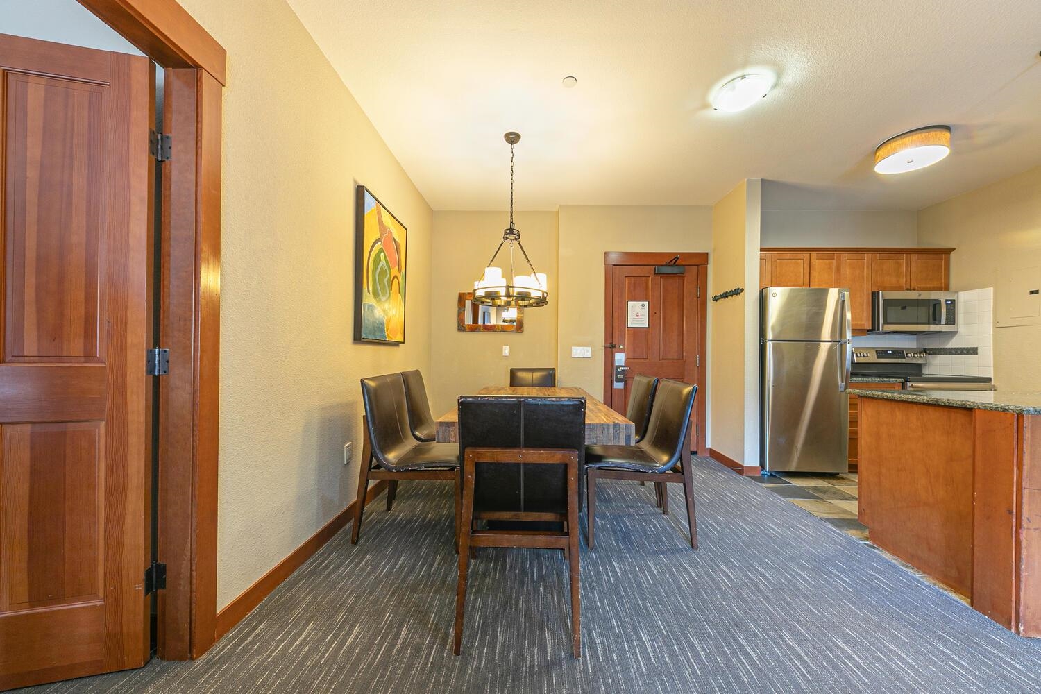 1985 Olympic Vly Road, Unit 2312 Olympic Valley, CA 96146 - Photo 18 of 27 a dining room with furniture a chandelier and wooden floor