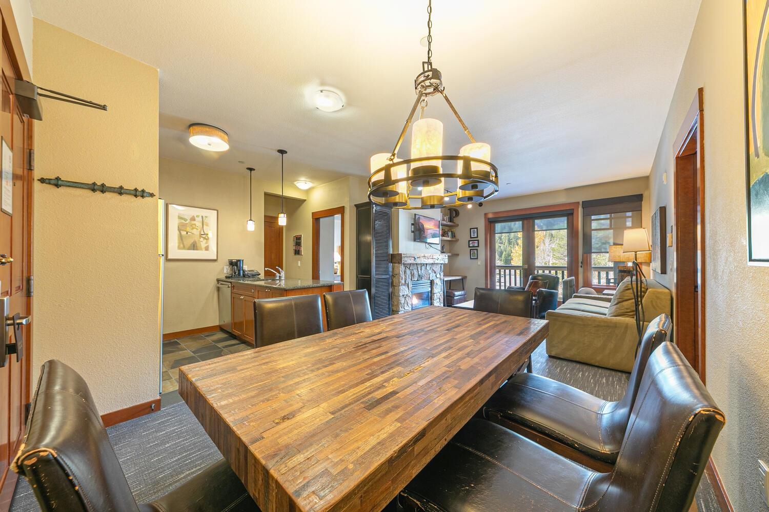 1985 Olympic Vly Road, Unit 2312 Olympic Valley, CA 96146 - Photo 19 of 27 a view of a dining room with furniture a chandelier and wooden floor