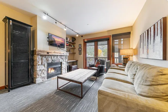 a living room with fireplace furniture and a fireplace