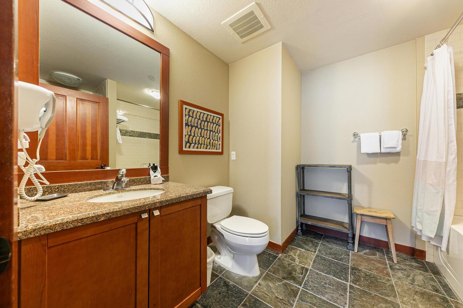 1985 Olympic Vly Road, Unit 2312 Olympic Valley, CA 96146 - Photo 6 of 27 a bathroom with a granite countertop toilet sink and mirror