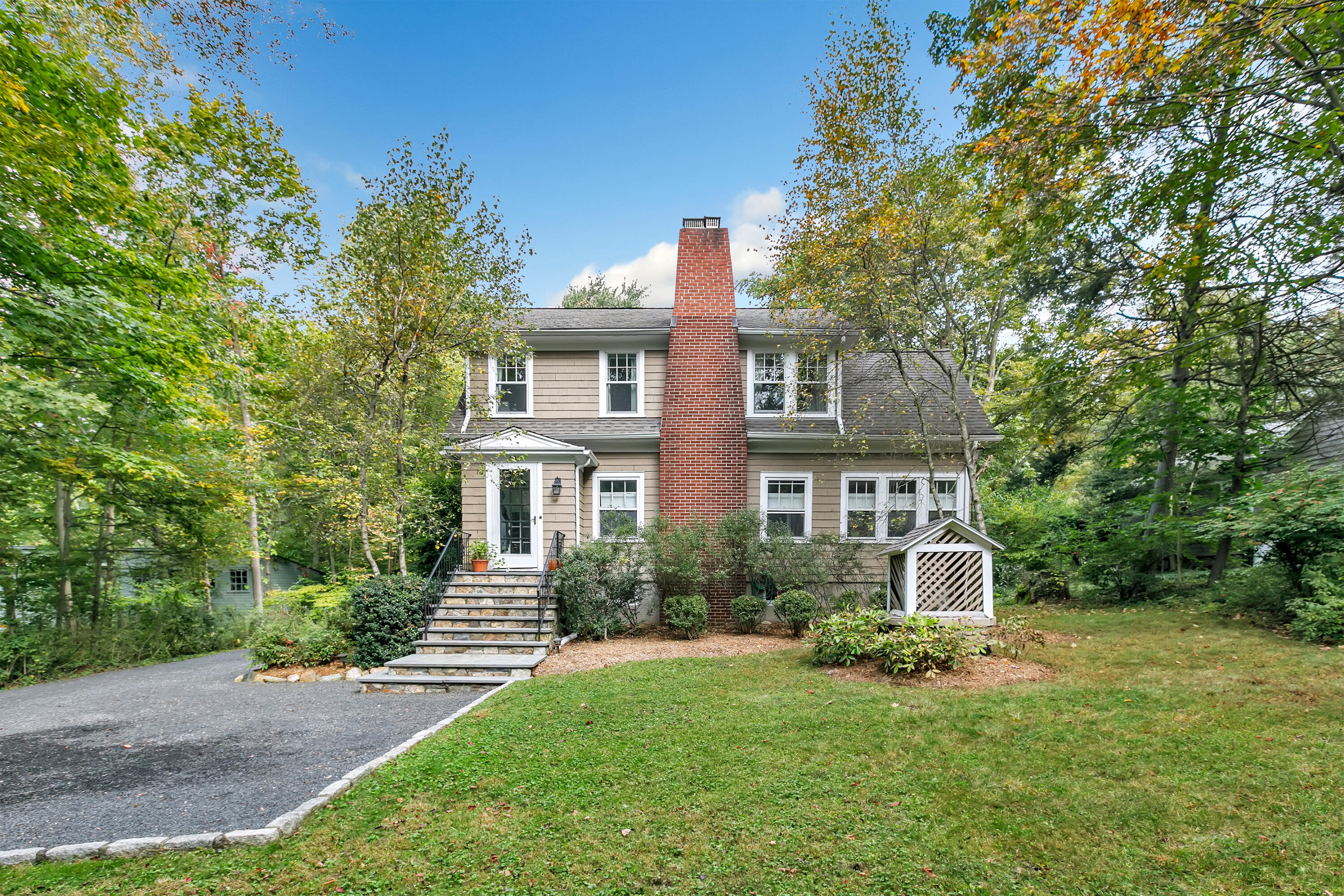 401 Jelliff Mill Road New Canaan, CT 06840 - Photo 1 of 21 a front view of a house with a yard and trees