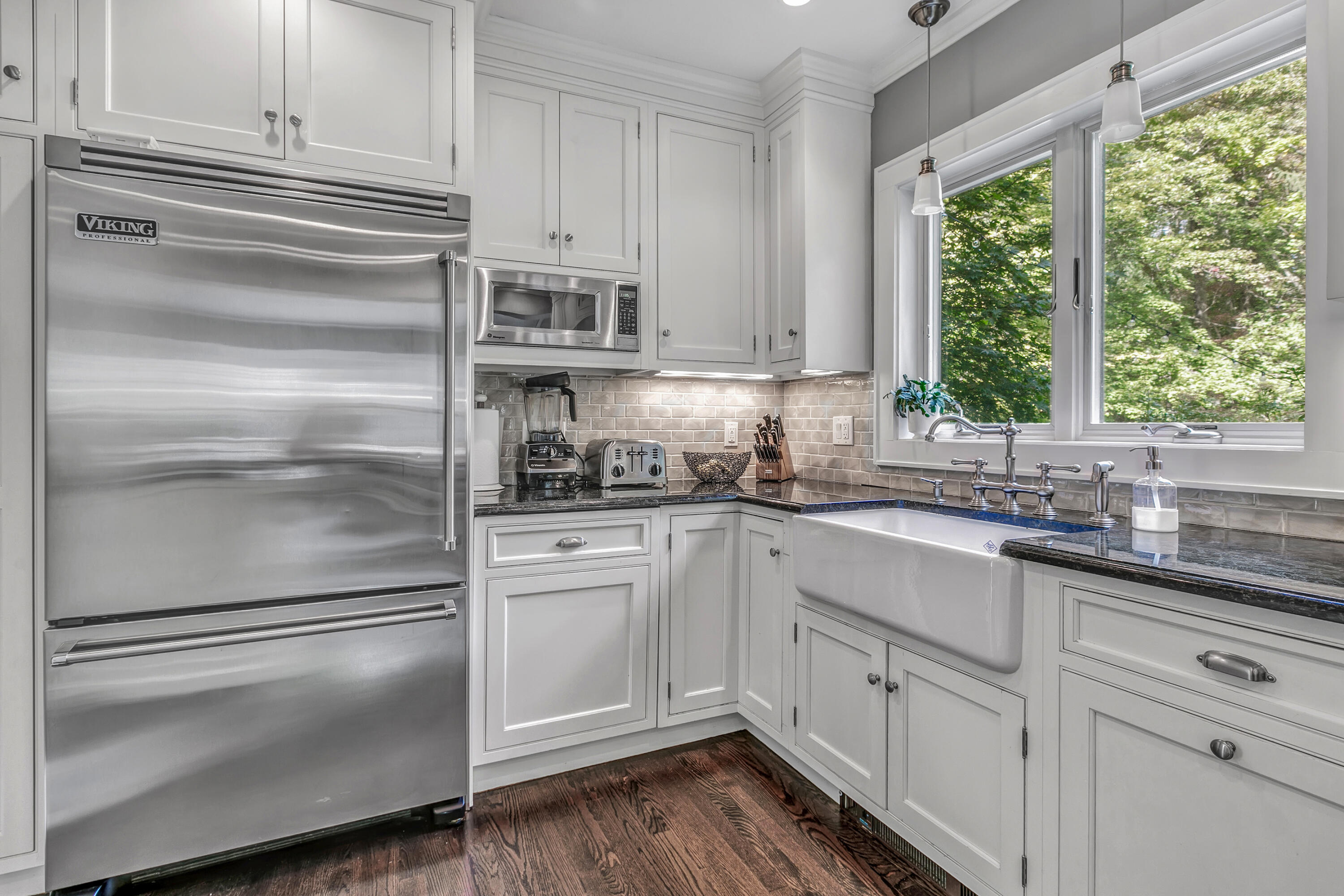401 Jelliff Mill Road New Canaan, CT 06840 - Photo 13 of 21 a kitchen with white cabinets and a window