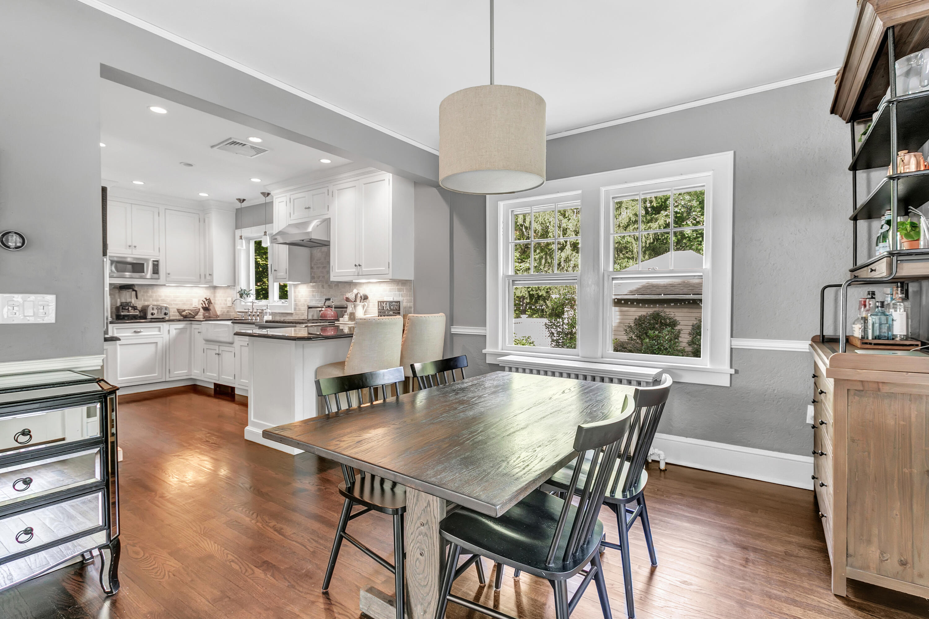 401 Jelliff Mill Road New Canaan, CT 06840 - Photo 9 of 21 a view of a dining room and livingroom with furniture wooden floor a rug a painting and a chandelier