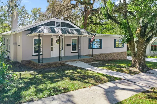 a view of house with yard