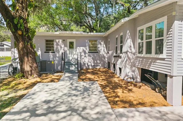a view of house with backyard