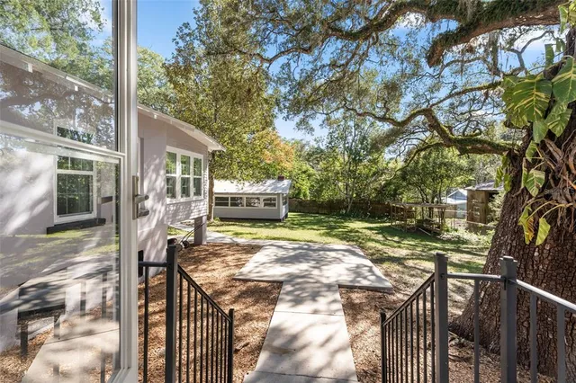 a view of a house with yard and a garden