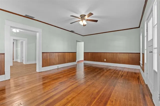 wooden floor in an empty room with a window