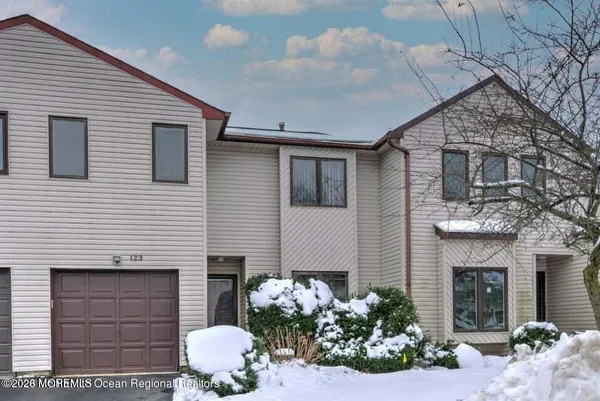 a front view of a house with potted plants