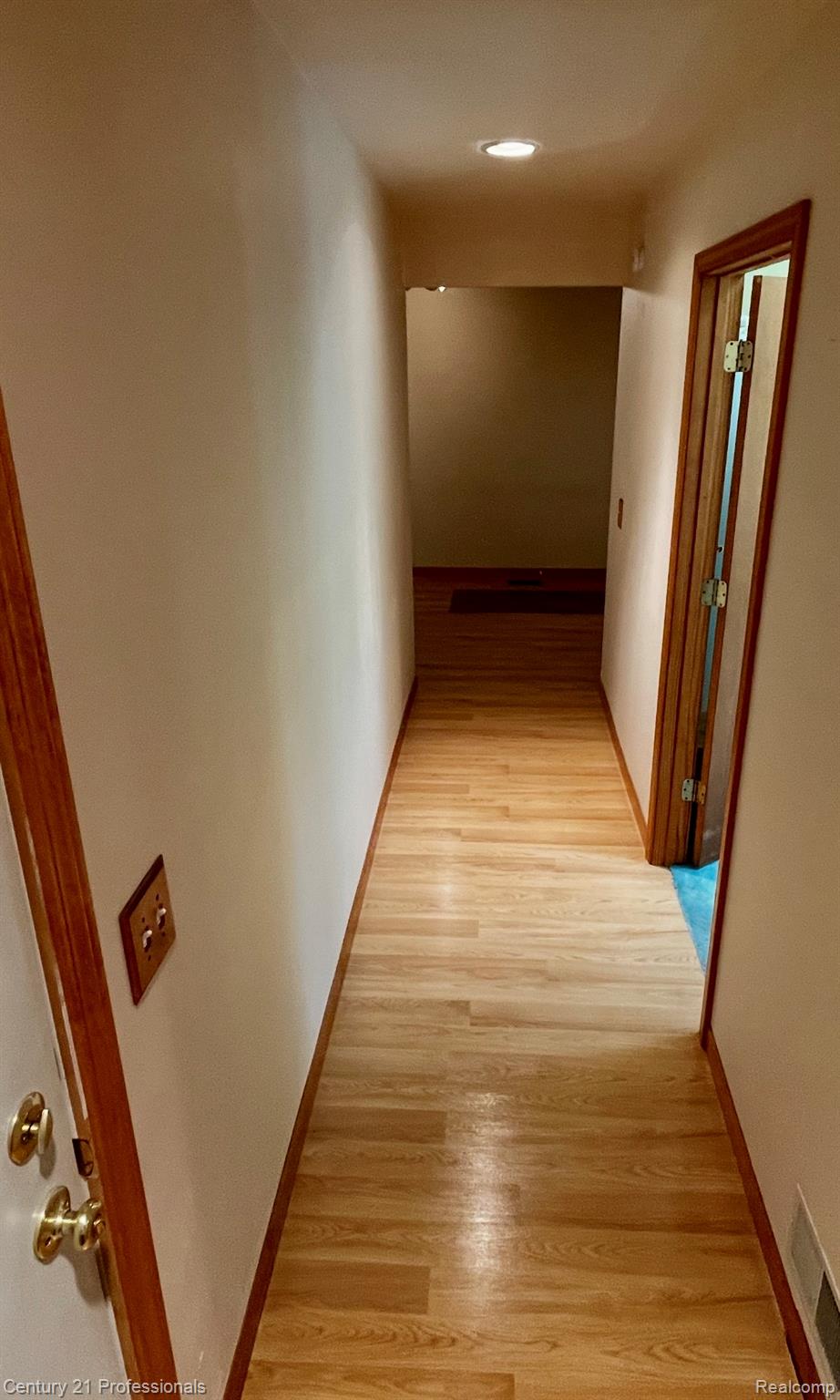 2903 Lake Angelus Road Waterford, MI 48329 - Photo 11 of 17 Hallway featuring wood-finish flooring with coordinating baseboards and door frames