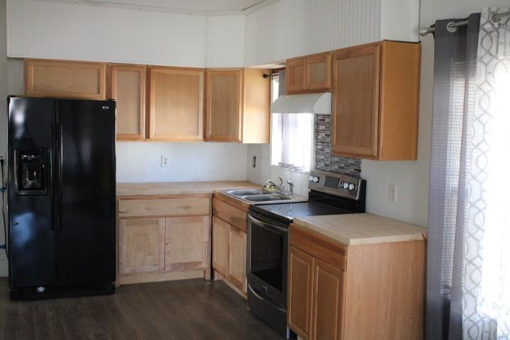 315 4th Street Hawley, TX 79525 - Photo 3 of 4 a kitchen with a sink a refrigerator and cabinets