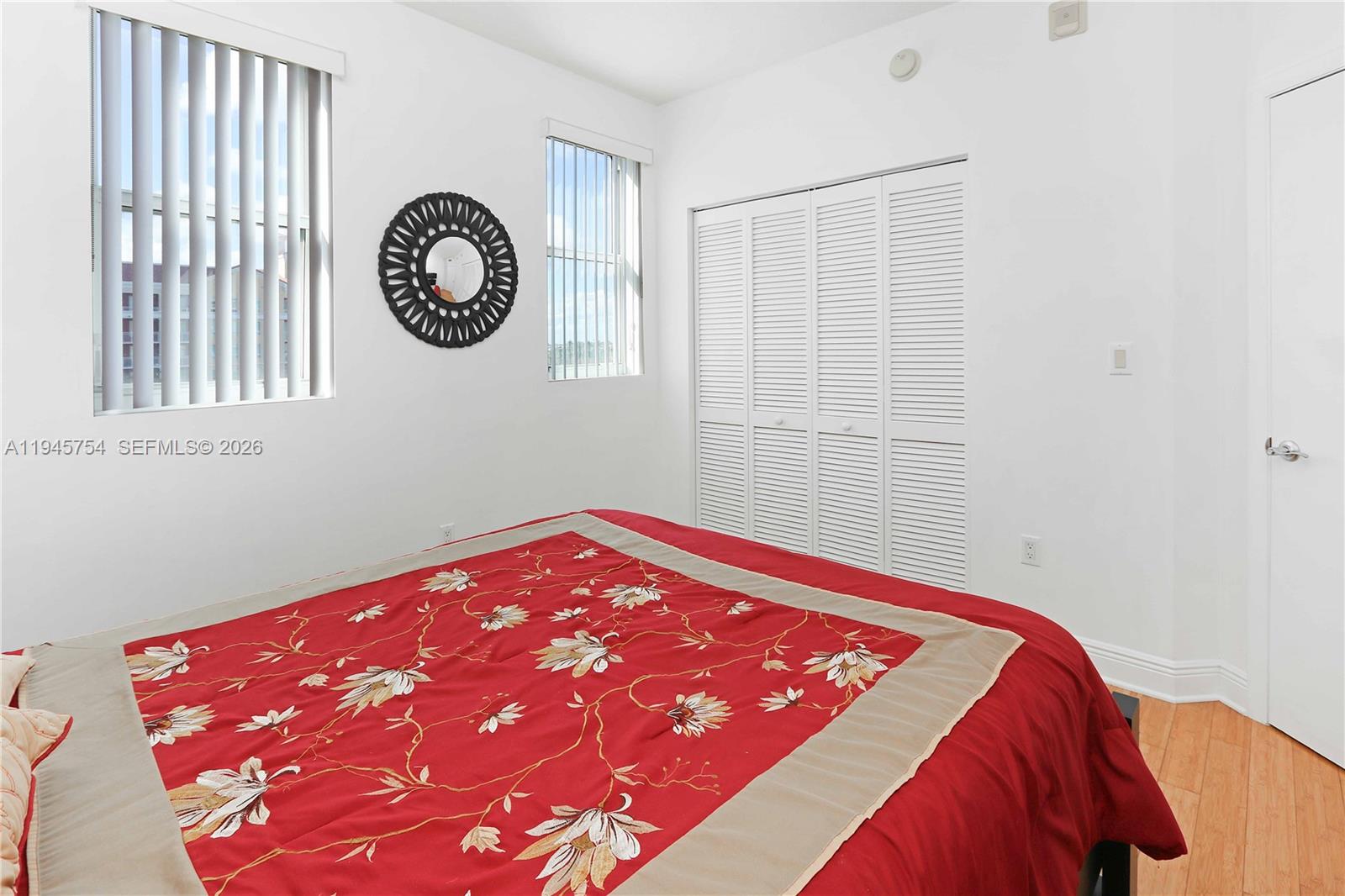 7275 Southwest 89th Street, Unit B416 Miami, FL 33156 - Photo 12 of 32 a view of a bedroom with wooden floor and a window
