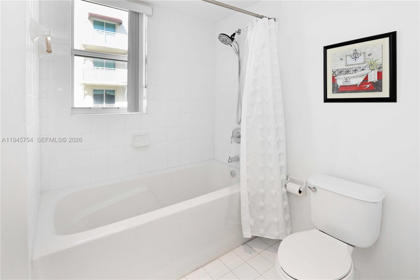 7275 Southwest 89th Street, Unit B416 Miami, FL 33156 - Photo 18 of 32 a white toilet sitting next to a bath tub