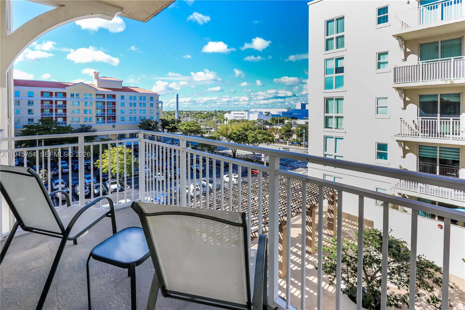 7275 Southwest 89th Street, Unit B416 Miami, FL 33156 - Photo 23 of 32 a view of a balcony with chairs