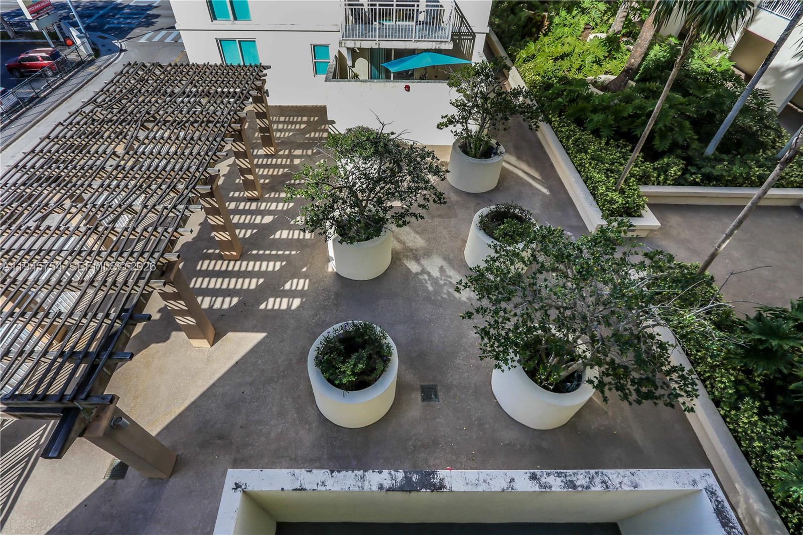 7275 Southwest 89th Street, Unit B416 Miami, FL 33156 - Photo 24 of 32 a view of a house with patio entertaining space