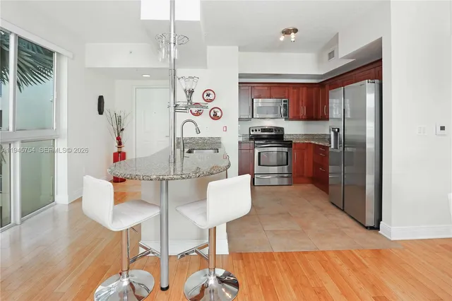 a kitchen with refrigerator and cabinets