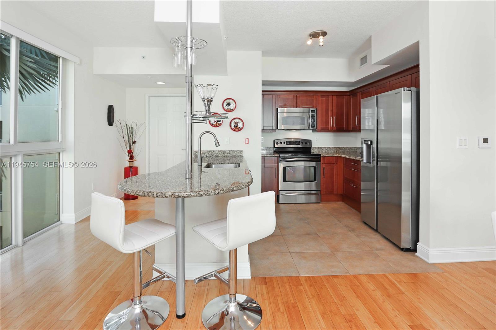 7275 Southwest 89th Street, Unit B416 Miami, FL 33156 - Photo 5 of 32 a kitchen with refrigerator and cabinets