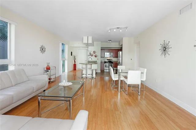 a living room with furniture and a wooden floor