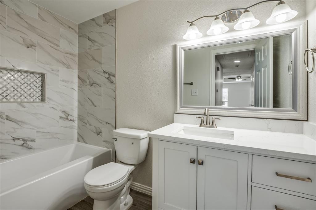 8940 Thompson Circle Frisco, TX 75033 - Photo 13 of 15 a bathroom with a sink toilet and shower