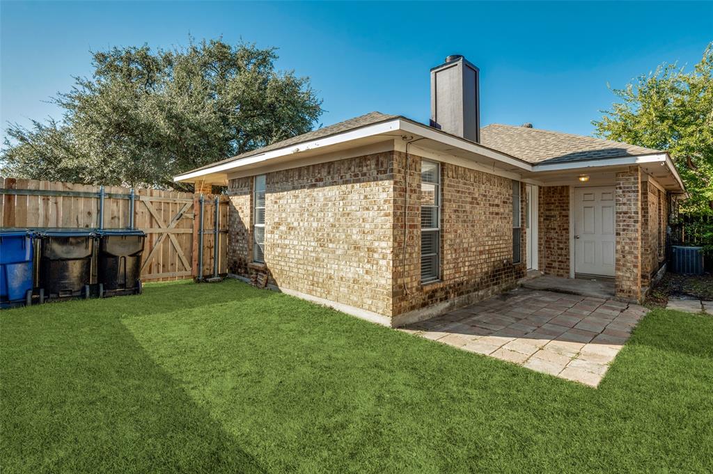 8940 Thompson Circle Frisco, TX 75033 - Photo 14 of 15 a front view of a house with garden