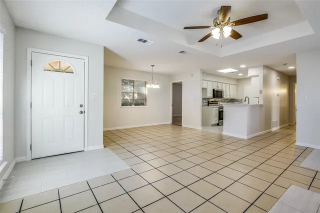 a view of a kitchen with a sink and refrigerator