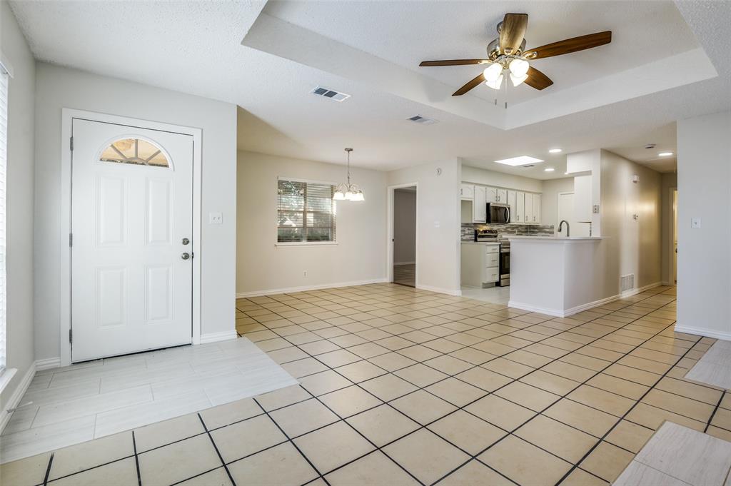 8940 Thompson Circle Frisco, TX 75033 - Photo 3 of 15 a view of a kitchen with a sink and refrigerator