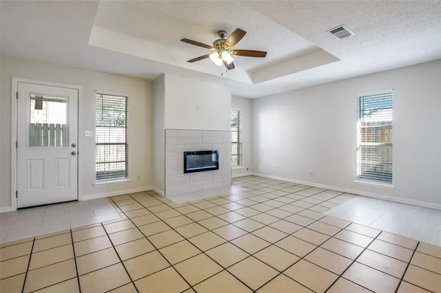 a view of an empty room with window and fireplace