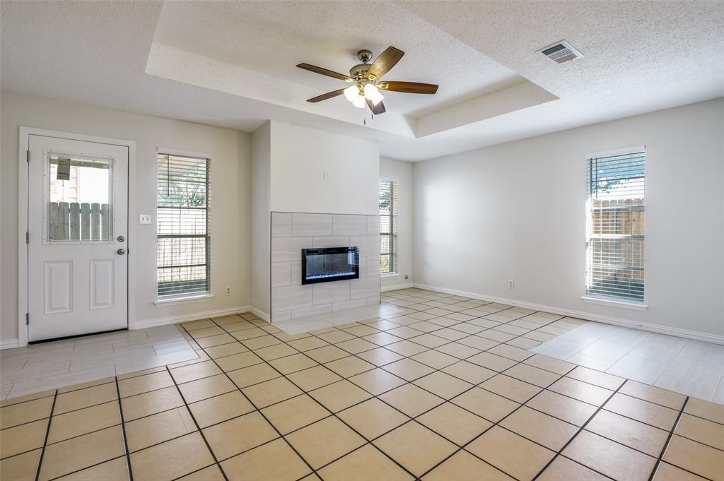 8940 Thompson Circle Frisco, TX 75033 - Photo 5 of 15 a view of an empty room with window and fireplace