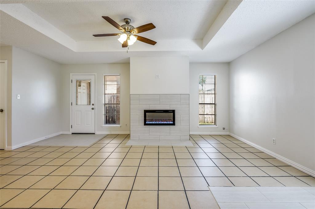 8940 Thompson Circle Frisco, TX 75033 - Photo 6 of 15 an empty room with windows and fireplace