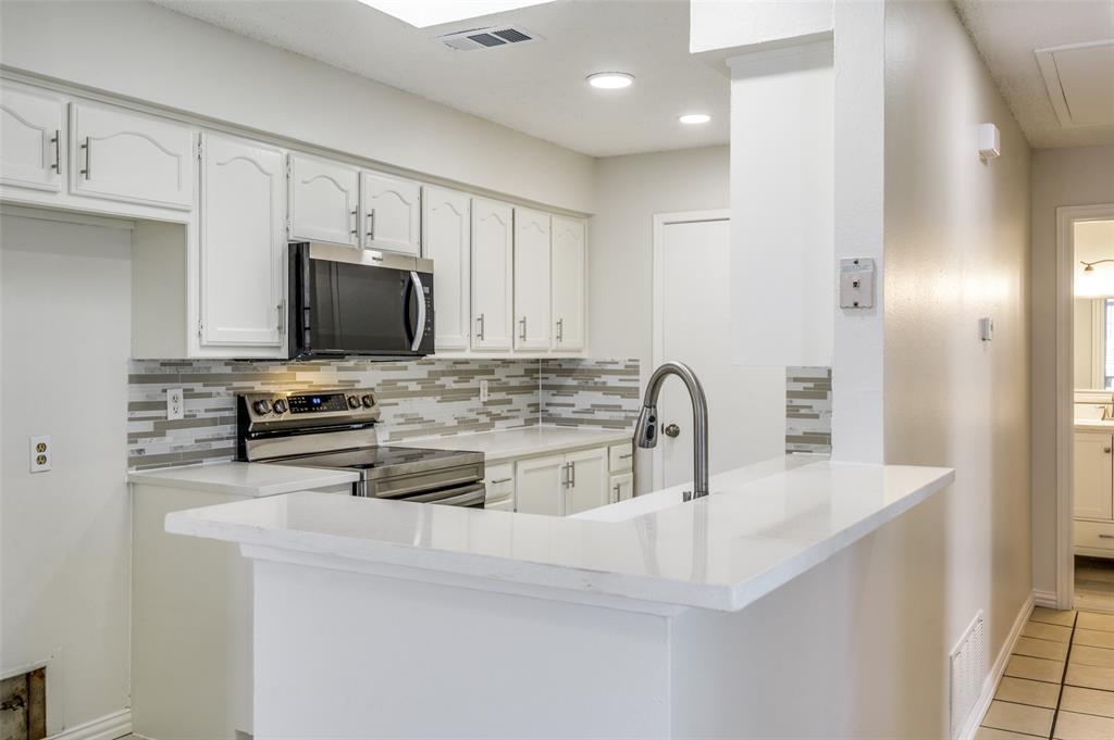 8940 Thompson Circle Frisco, TX 75033 - Photo 7 of 15 a kitchen with stainless steel appliances a stove a sink a microwave and refrigerator