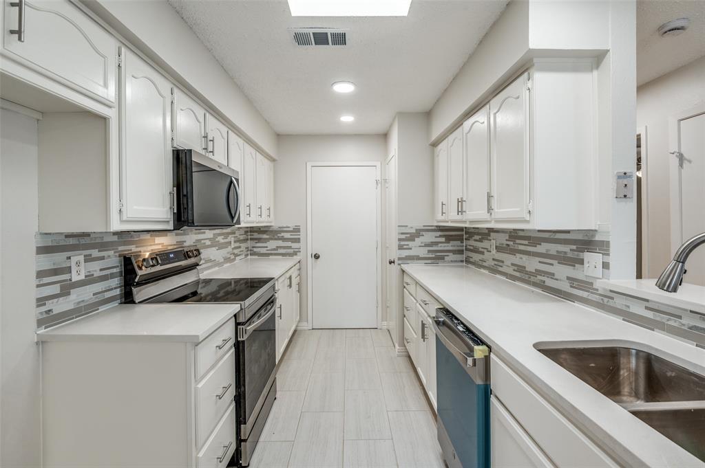 8940 Thompson Circle Frisco, TX 75033 - Photo 8 of 15 a kitchen with stainless steel appliances granite countertop a sink stove and refrigerator