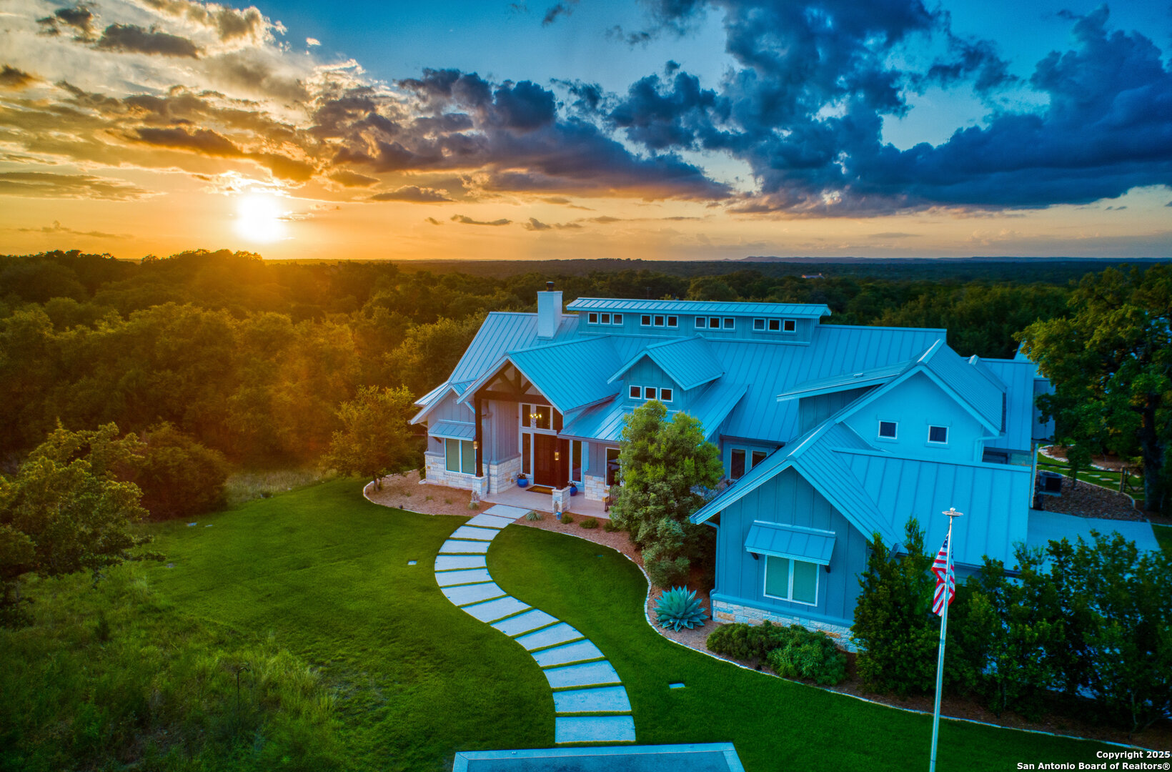 a view of a big house with a big yard and potted plants