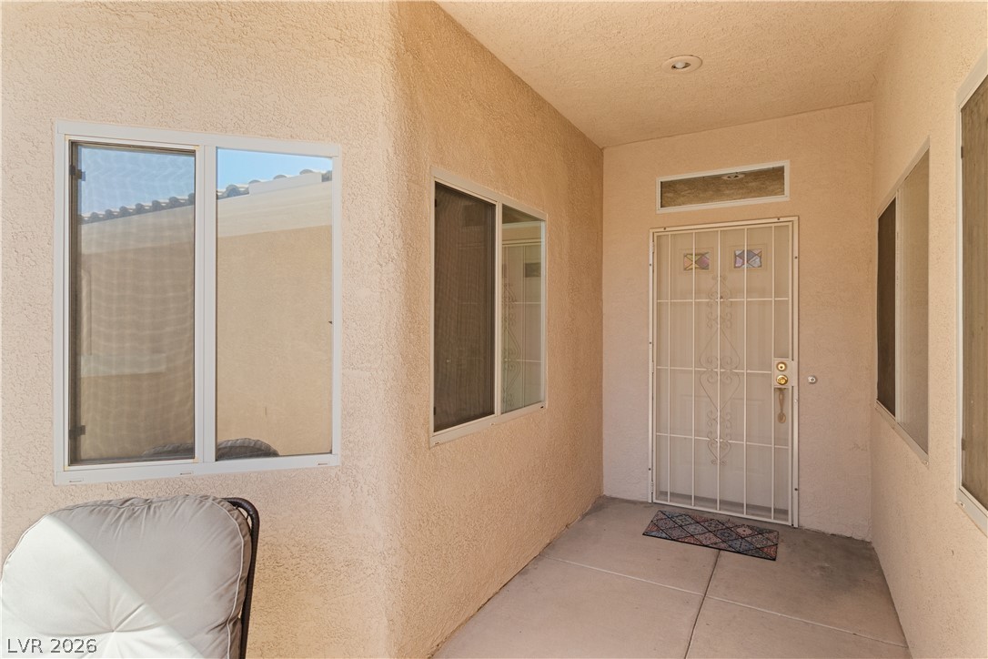 3376 Partridge Run Street Laughlin, NV 89029 - Photo 6 of 92 Secure entry to a charming residence, featuring a decorative security door and convenient side windows.