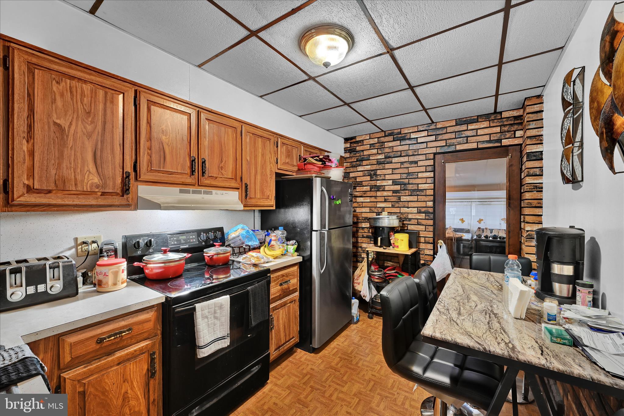 936 Pike Street Reading, PA 19604 - Photo 11 of 24 a kitchen with stainless steel appliances granite countertop a stove a sink dishwasher and cabinets with wooden floor