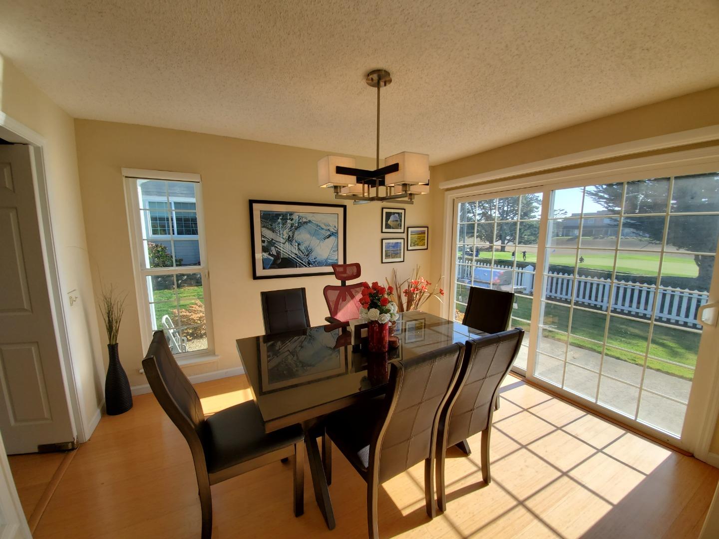 13 Merion Road Half Moon Bay, CA 94019 - Photo 6 of 14 a dining room with furniture a chandelier and window
