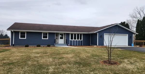 a house that has a tree in front of it