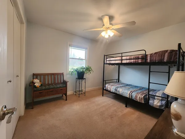 a bedroom with a bed and a chandelier