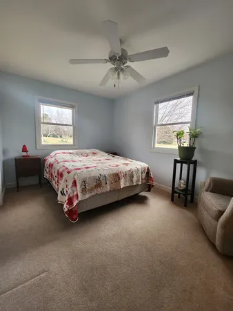 a spacious bedroom with a bed and a couch
