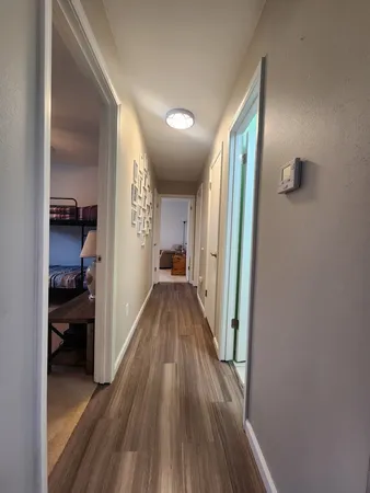 a view of a hallway view with wooden floor and staircase