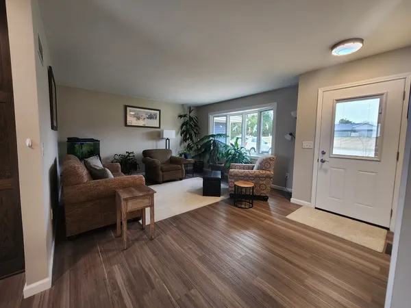 a living room with furniture and a hard wood floor