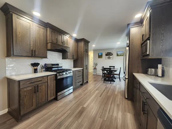 a kitchen with a sink cabinets and stainless steel appliances