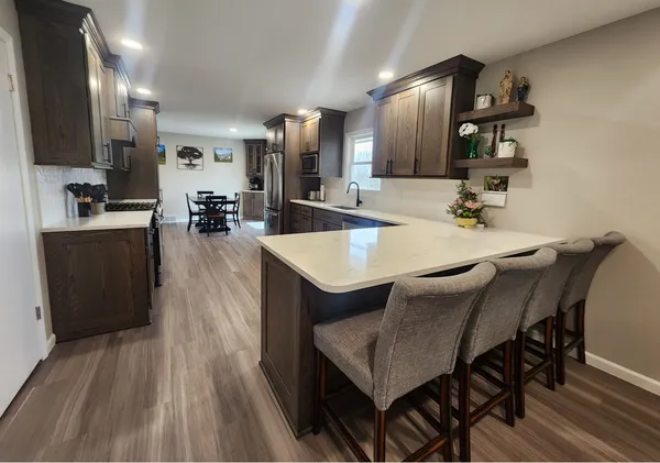 a large kitchen with a table and chairs