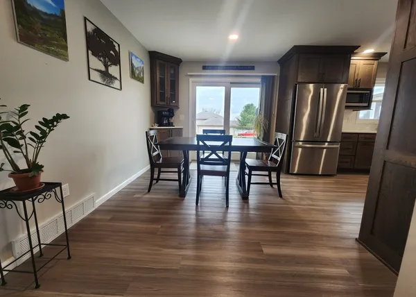 a view of a dining room with furniture window and wooden floor