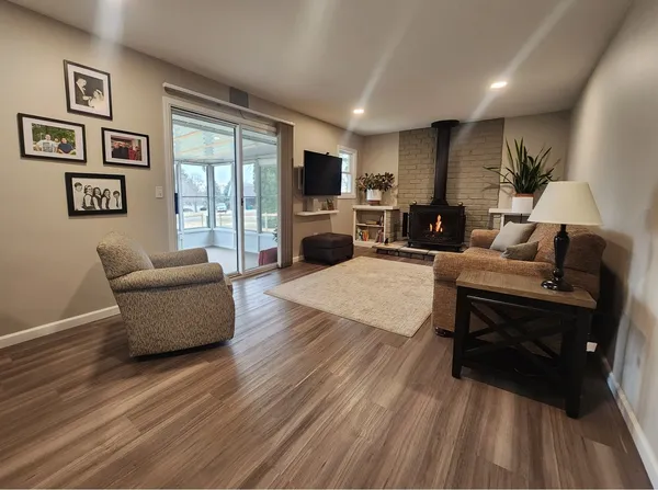 a living room with furniture fireplace and window