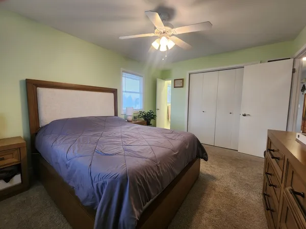 a bedroom with a large bed and a chandelier